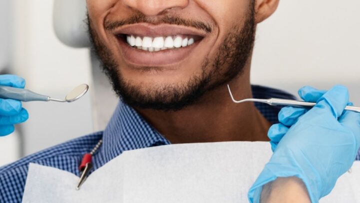 A close-up of a smiling patient showcasing bright, perfectly aligned teeth after cosmetic dental treatment.