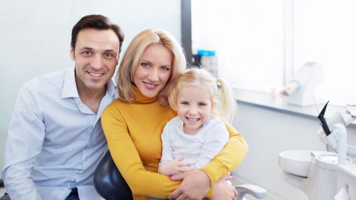 A happy family visiting a dentist for routine checkups.