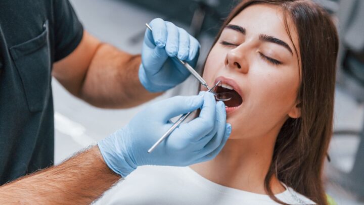 Woman receiving calming dental treatment .