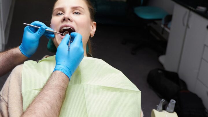 Dentist examining a patient’s teeth during a routine dental checkup.