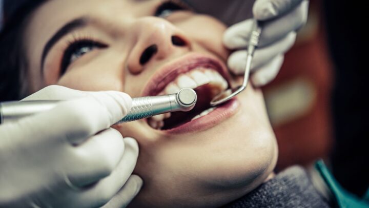 Dentist examining dental filling to ensure long-lasting tooth restoration.