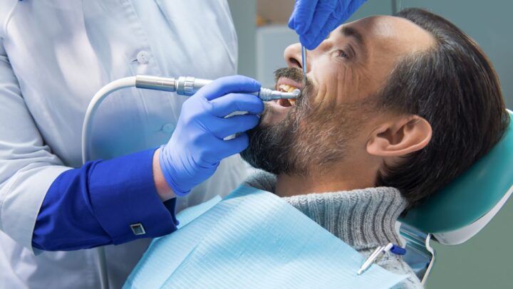 Dentist performing a root canal treatment to save a natural tooth.