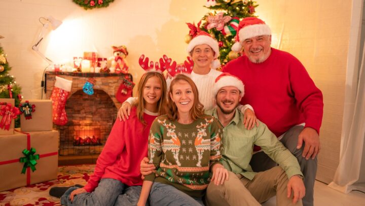 A family smiling during Christmas , highlighting healthy holiday smiles and proper oral care.